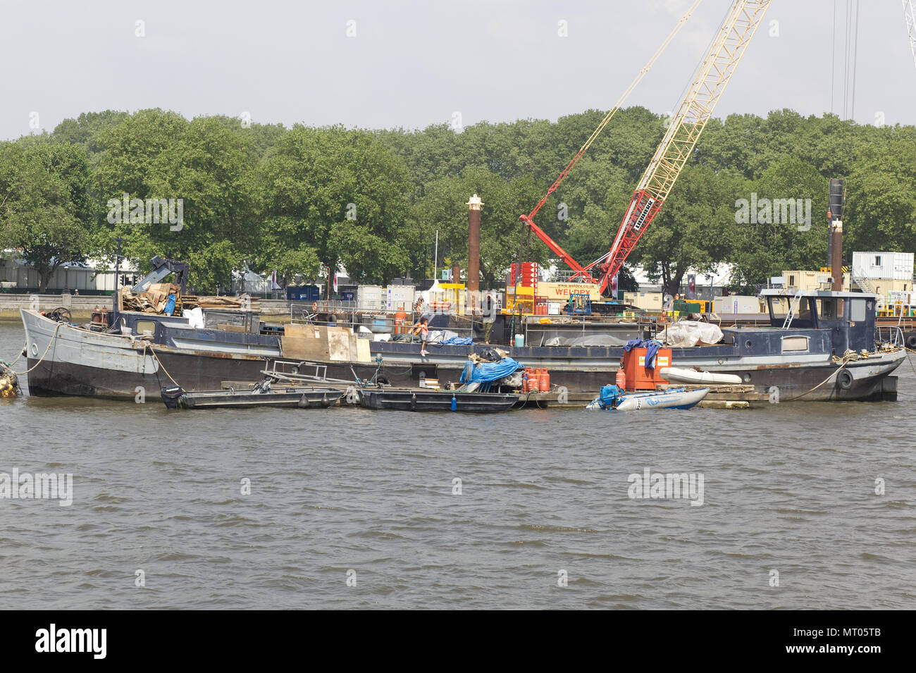 cleaning the river thames with cranes and barges Stock Photo