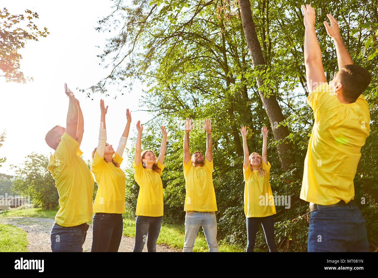 Young people in teambuilding workshop doing a stretching exercise in nature  Stock Photo - Alamy