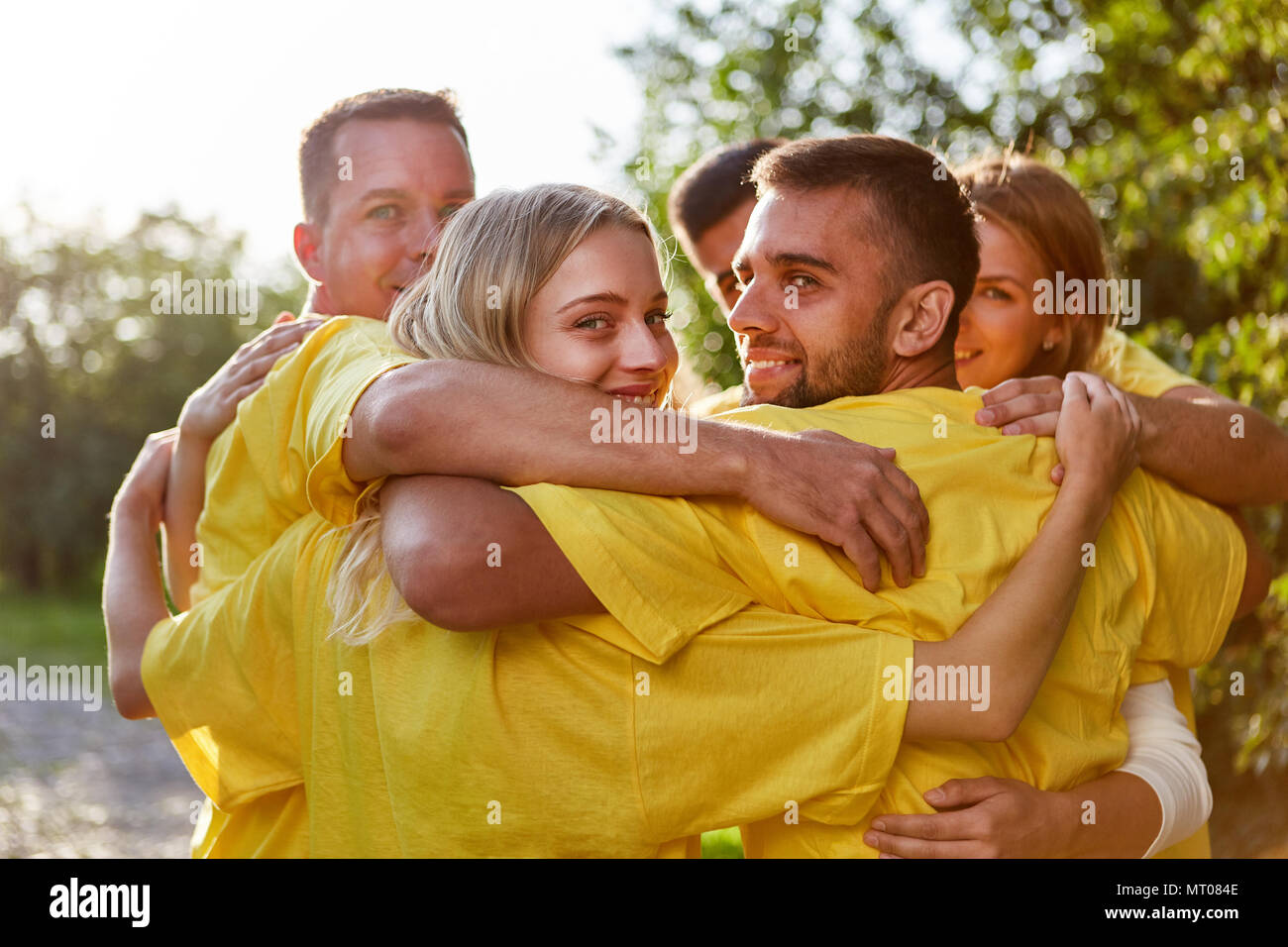 Young people as a group and as friends at the teambuilding event in nature Stock Photo