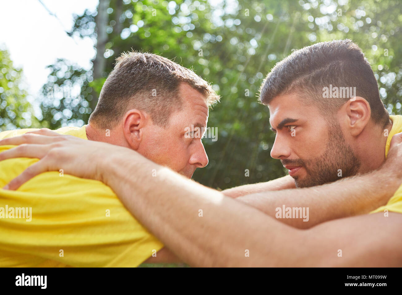 Two young men are training confrontation at a teambuilding workshop Stock Photo