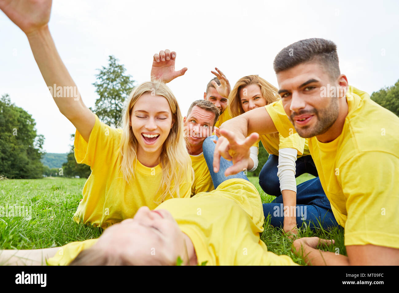 Happy team celebrates success after a competition on a meadow Stock Photo