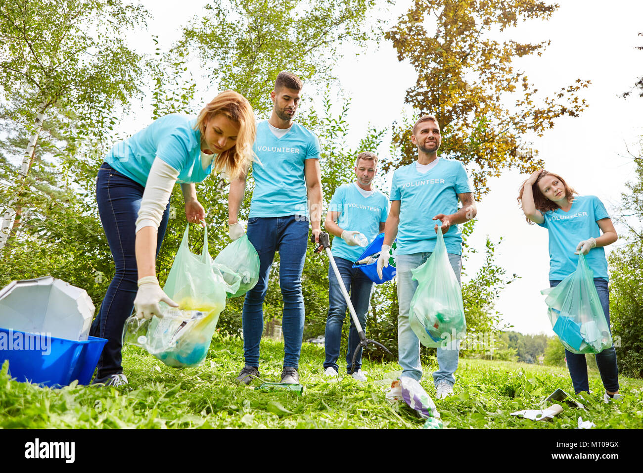 Group of volunteers and activists collecting garbage for environmental ...