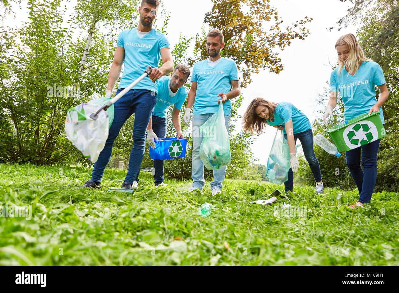 Young people as volunteers collect garbage for a conservation project