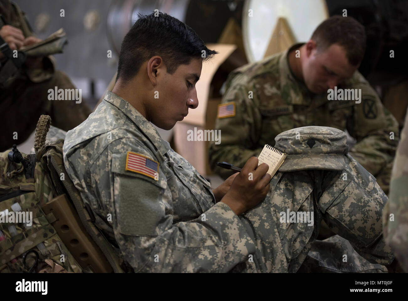 U.S. Army Spc. Saul Hernandez, infantryman, Alpha Company, 3rd Battalion, 172nd Infantry Regiment, 86th Infantry Brigade Combat Team (Mountain), Vermont National Guard, take notes while being briefed operations orders at Camp Ethan Allen Training Site, Jericho, Vt., July 15, 2017.  The Soldiers were preparing for a squad training exercise that included patrolling, crossing vertical danger areas and squad attacks. (U.S. Air National Guard photo by Tech. Sgt. Sarah Mattison) Stock Photo