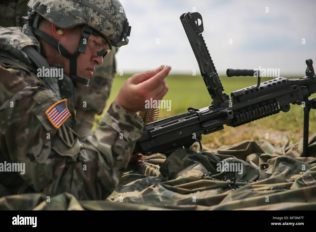 Sergeant Light Machine Gun U.S. Army Staff Sgt. Jared Casey loads 5.56mm linked ammunition on a ...