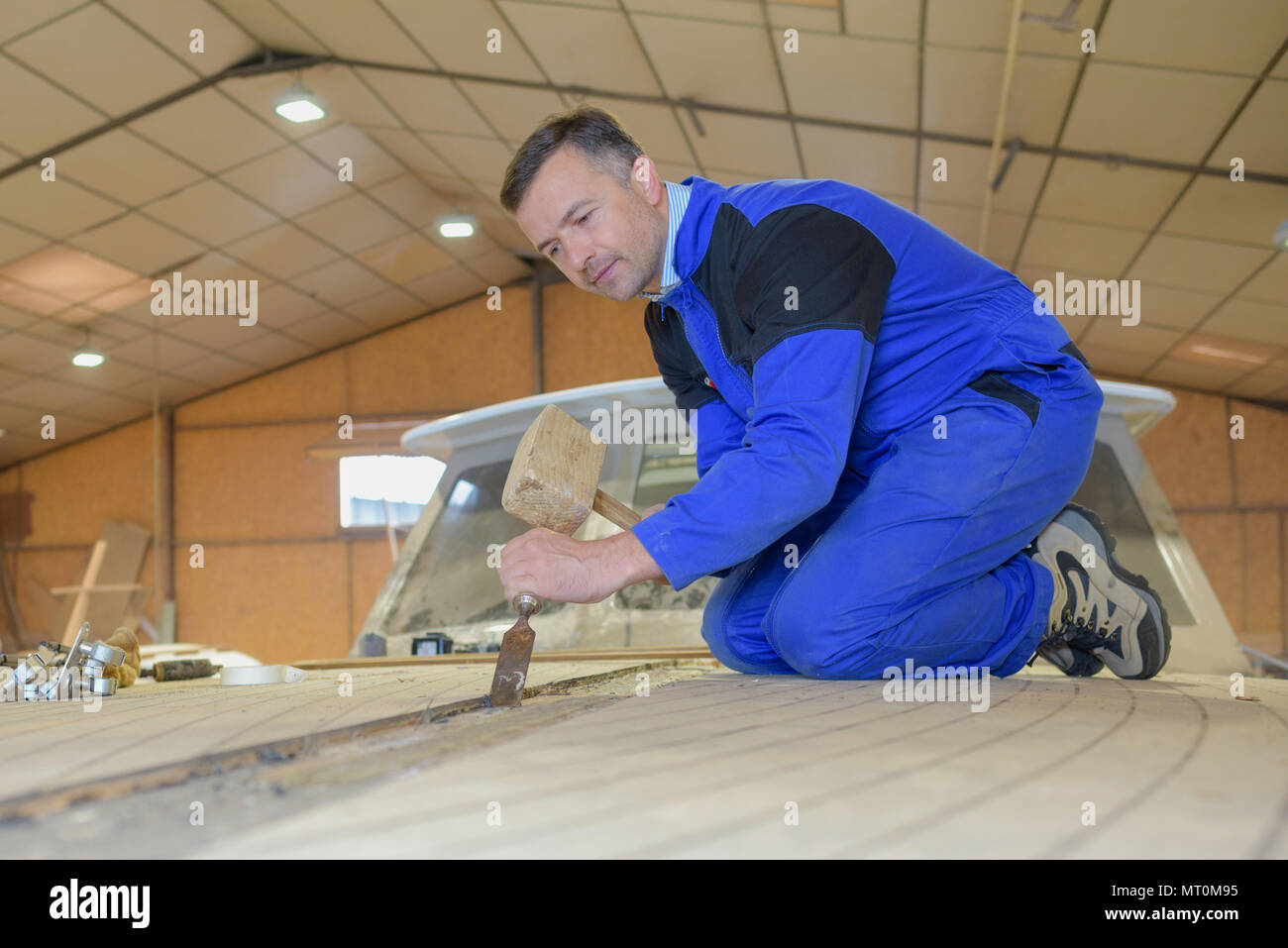 male carpenter using hammer and chisel Stock Photo Alamy