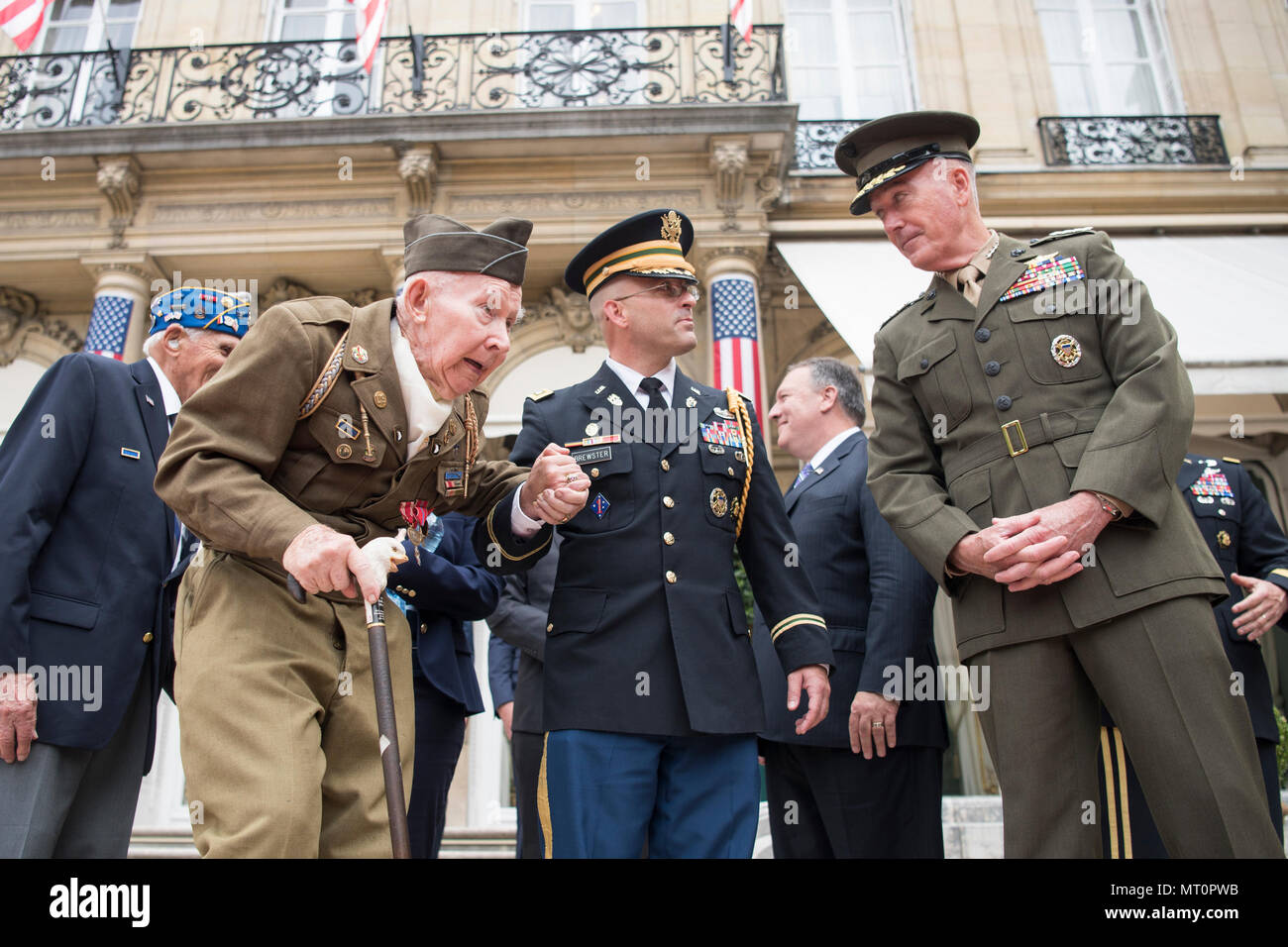 Army Lt. Col. Jessie Brewster, Aide de Camp to Marine Corps Gen. Joseph F. Dunford Jr., chairman of the Joint Chiefs of escorts a World War 2 veteran to his seat,