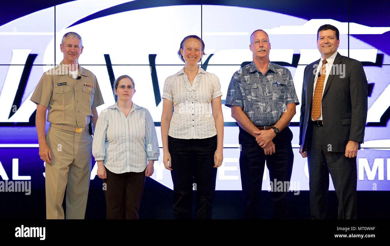 Naval Sea Systems (NAVSEA) Commander Vice Adm. Tom Moore, left, and NAVSEA Executive Director Mr. Jim H. Smerchansky, far right, present members of Naval Surface Warfare Center (NSWC), Carderock Division’s Radar Cross Section (RCS) Measurement System Upgrade Simultaneous Data Collection Team a 2017 NAVSEA Commander's Award for Innovation in the Humphreys Building at the Washington Navy Yard July 19. Four other entrants also received the NAVSEA Commander's Award for Innovation this year: Kenneth A. Fischer of NSWC Philadelphia; the Supervisor of Shipbuilding, Conversion and Repair Groton, Conne Stock Photo