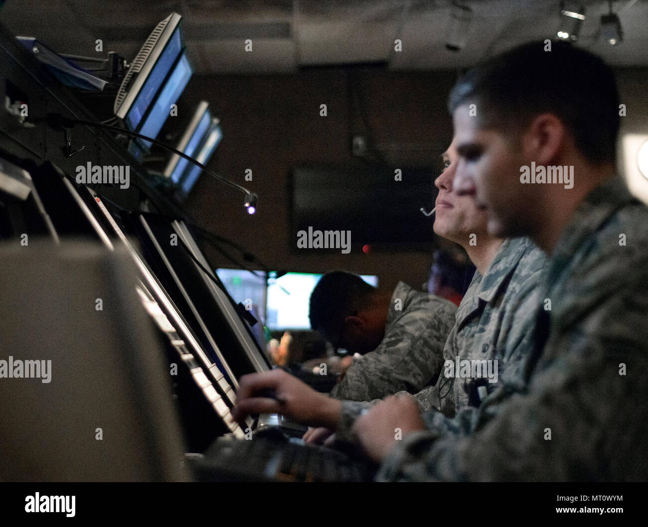 Airmen from the 71st Operations Support Squadron at work at the Radar Approach Control facility at Vance Air Force Base, Oklahoma, July 10. Clearance and Delivery air traffic controllers like the ones you see here receive and confirm flight plans before filtering them to awaiting controllers. (U.S. Air Force photo by David Poe) Stock Photo