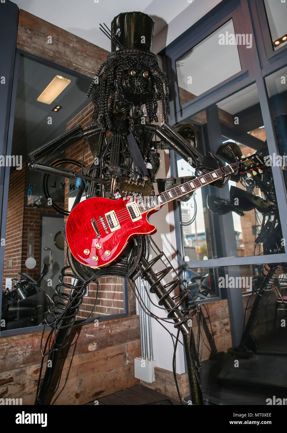 A unique sculpture of rock musician Slash is going under the hammer.  The larger-than-life, 7.5 feet tall work has been painstakingly fashioned from recycled car, bike and instrument parts.  Officially signed by Slash in two places, it is the work of artist Simon Weitzman and welder/finisher Darren Kenny, of Heavy Metal Sculptures (https://www.heavymetalsculptures.com/)  It was made to benefit IFAW, the International Fund for Animal Welfare, of which Slash acts as an ambassador, and comes fitted with a Slash signature guitar.  The piece has a starting bid of £1,800 and will be sold by Omega Au Stock Photo