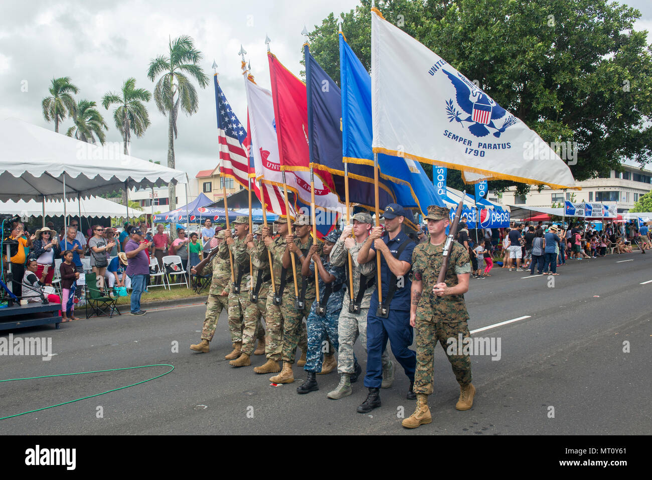 U.S. service members march during the 73rd Guam Liberation Day parade July 21, 2017, in Hagåtña, Guam. The parade commemorated 73 years since U.S. armed forces liberated the island from Japanese occupation. During World War II, Japan seized Guam on December 10, 1941, and on July 21, 1944, the U.S. armed forces liberated the island. (U.S. Air Force photo by Airman 1st Class Christopher Quail) Stock Photo