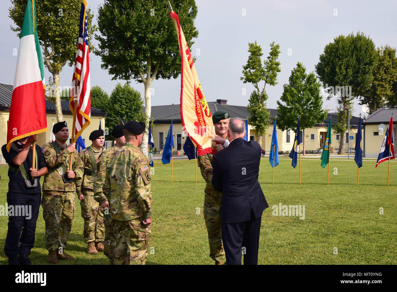 Michael D. Formica, Region Director, Installation Management  Command-Europe, receives the colors from Col. Steven M. Marks, outgoing  commander at the garrison change of command ceremony on Hoekstra Field,  Caserma Ederle, Vicenza, Italy,