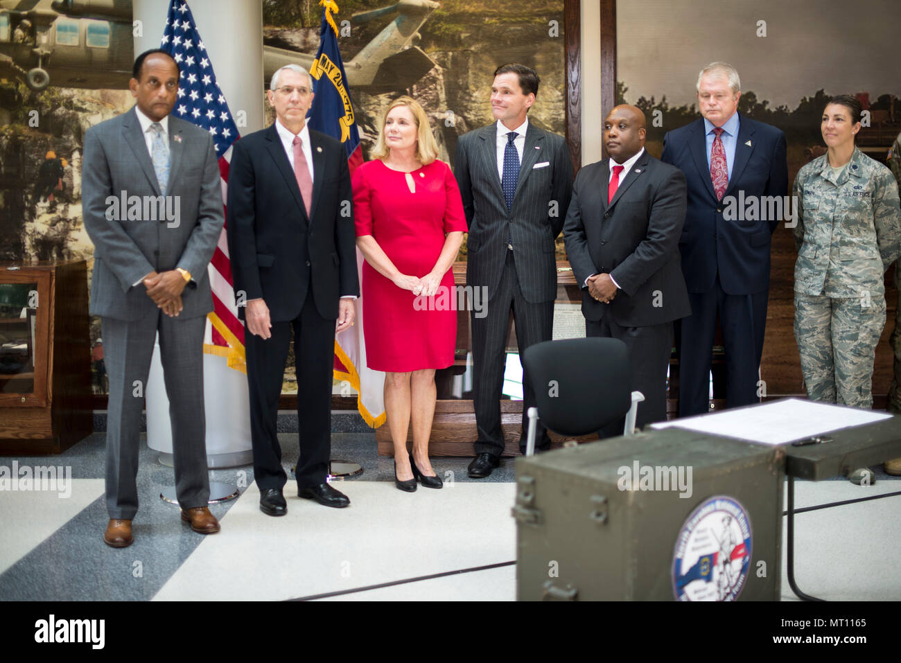 RALEIGH, N.C. - North Carolina Gov. Roy Cooper signs into law three bills expanding the rights and protections of Guardsmen at Joint Force Headquarters in Raleigh, N.C., July 21, 2017. These bills protect soldiers and airmen while attending North Carolina universities and colleges while on state active duty, Guardsmen re-employment rights and authorization for currently serving and retirees to purchase from Correction Enterprises. (U.S. Army National Guard photo by Sgt. Lisa Vines) Stock Photo