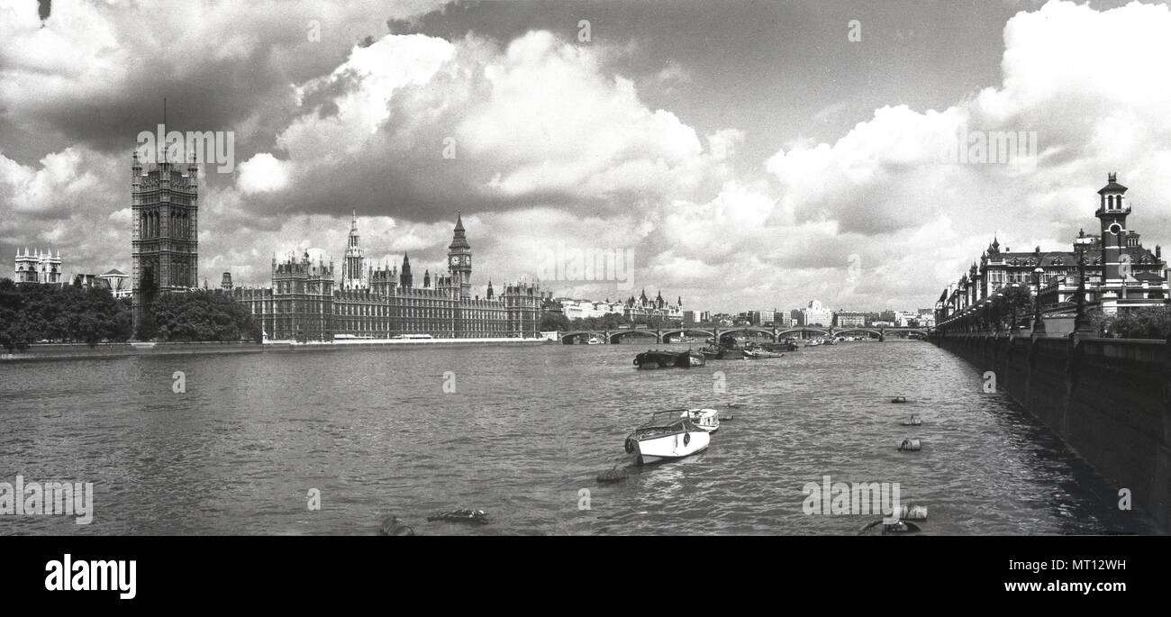 1950s, historical, a wide view down and across the River Thames, London, showing on the left, the Palace of Westminster, meeting place of the UK Government. At the palace are the two Houses of Parliament, the House of Commons and the House of Lords. Stock Photo