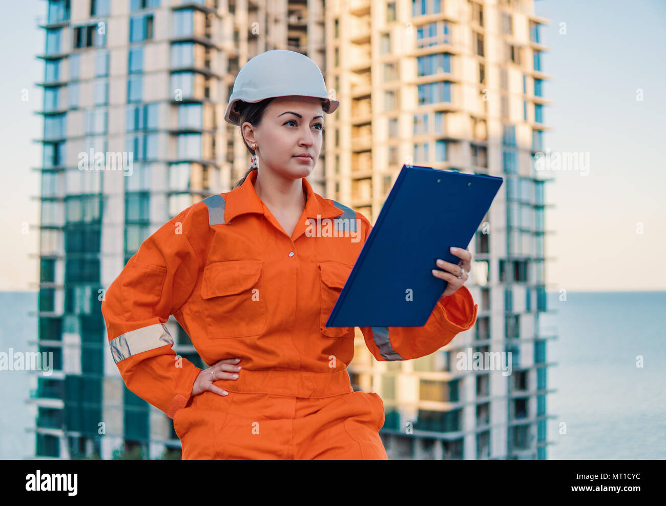 beatiful business woman engineer wearing orange coverall Stock Photo