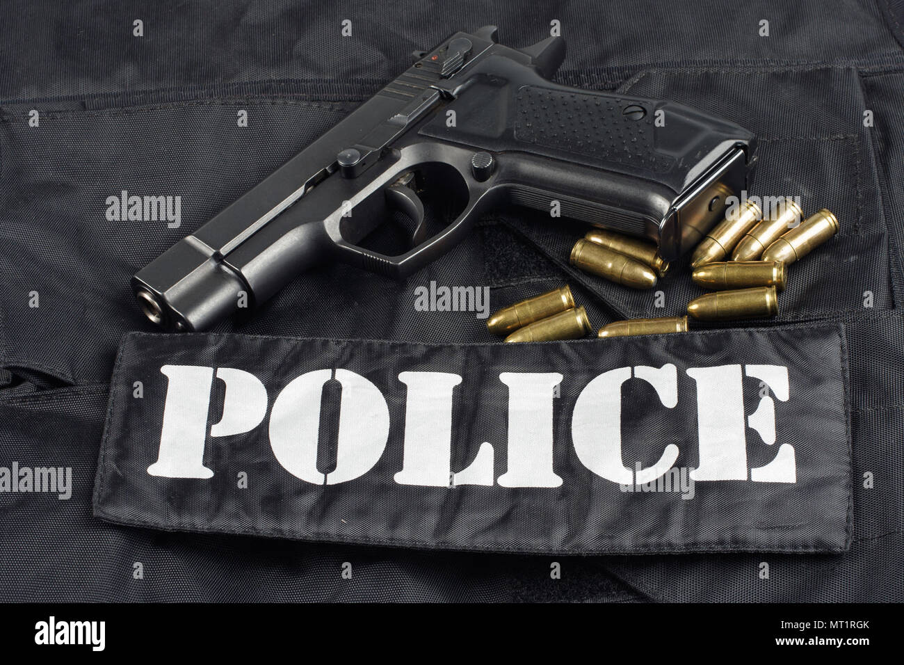 police handgun on black uniform background Stock Photo - Alamy