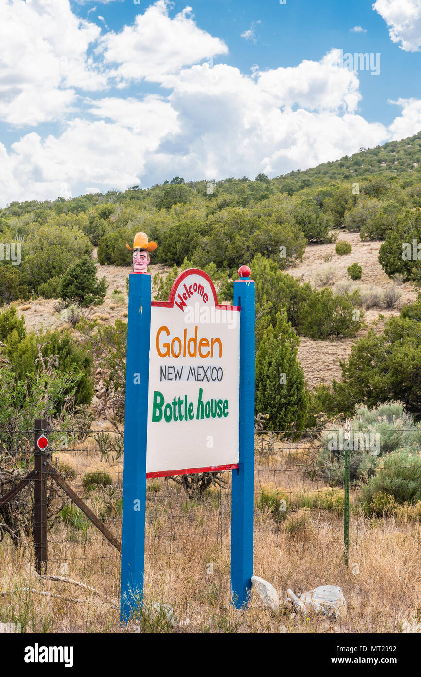 A colorful roadside sign for the Bottle House, a unique attraction, in
