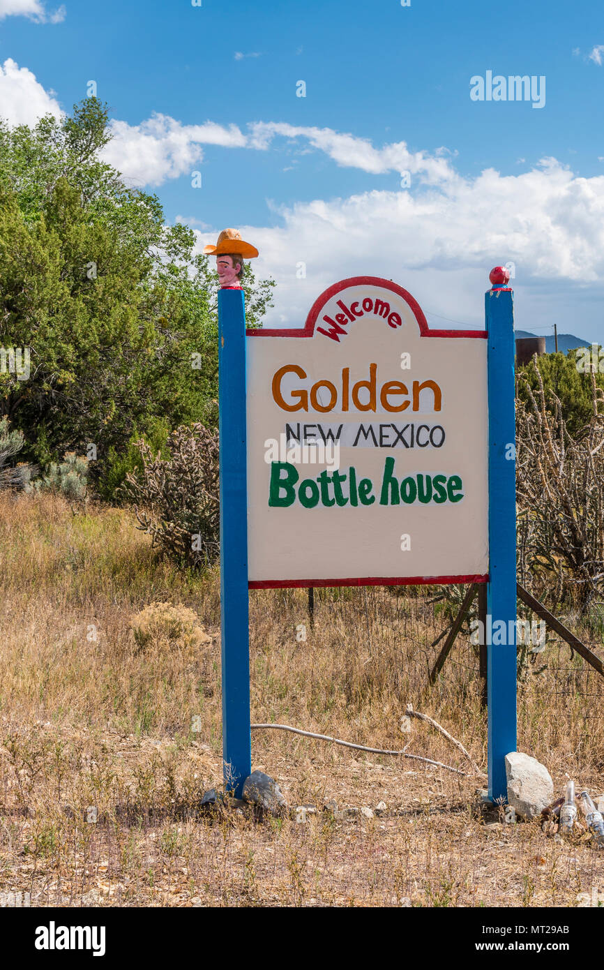 A colorful roadside sign for the Bottle House, a unique attraction, in