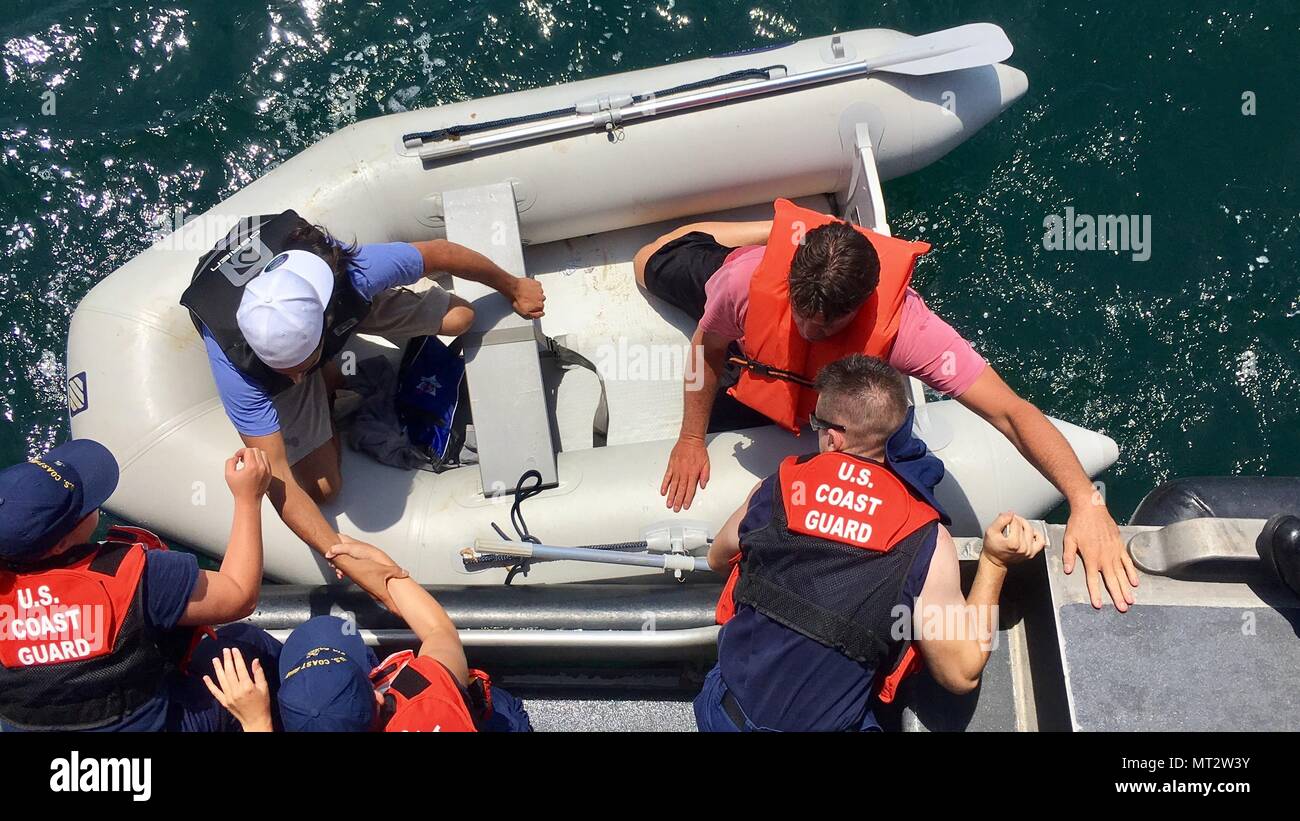 Coast Guard crews and a good Samaritan rescued two people 40 miles south of Sandy Hook, New Jersey, July 21, 2017 after their boat sank. At 9:39 a.m., watchstanders at the first Coast Guard District command center received a distress alert from an EPIRB onboard a 35-foot center console boat, 40 miles off of the coast of Sandy Hook. U.S Coast Guard photo by Seaman Dalton Stegent. Stock Photo