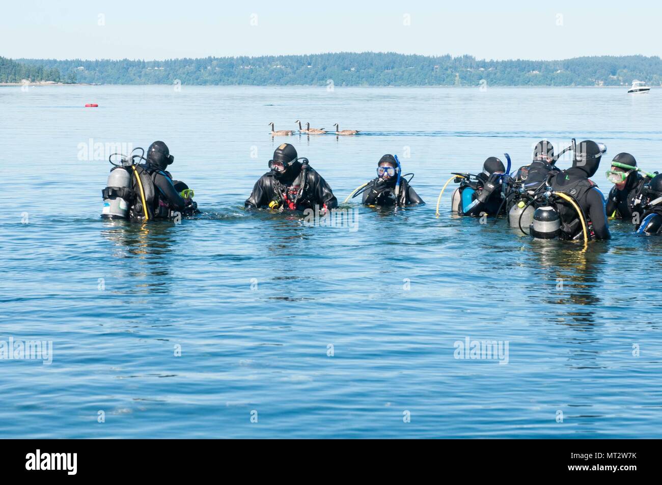 Mike Nebel a dive instructor with the Northwest Adventure Center on Joint Base Lewis-McChord, leads dive students in pre-dive inspections and buoyancy checks during a open water scuba class at Sunnyside Beach in Steilacoom, Washington, June 24, 2017. (U.S. Army photo by Sgt. Youtoy Martin, 5th Mobile Public Affairs Detachment) Stock Photo