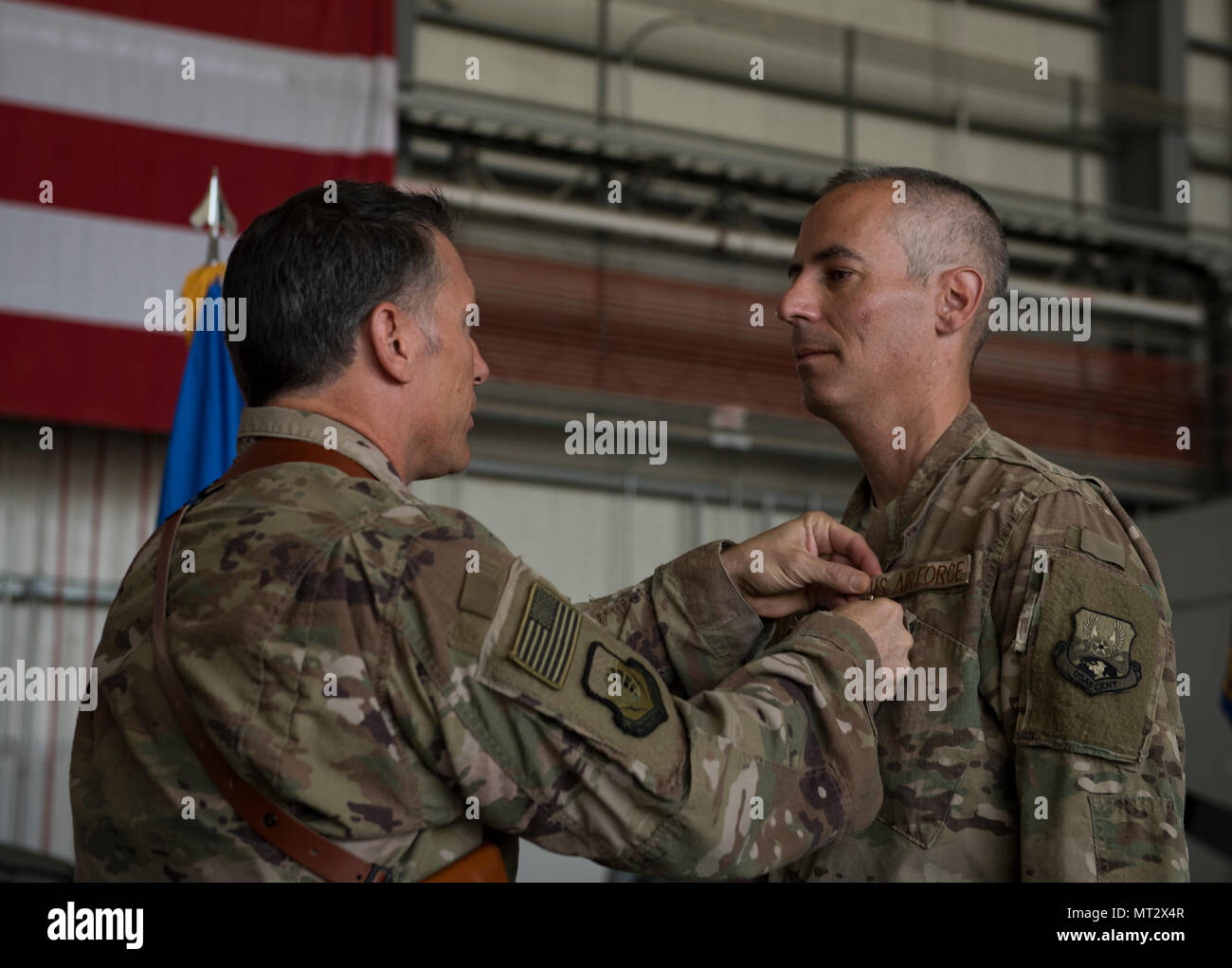 Col. Bradford Coley, the outgoing 455th Expeditionary Mission Support Group commander, receives the Bronze Star Medal from Brig. Gen. Craig Baker, the 455th Air Expeditionary Wing commander, during the 455th EMSG change of command ceremony at Bagram Airfield, Afghanistan, July 20, 2017. Coley commanded the 455th EMSG for the last 12 months. (U.S. Air Force photo by Staff Sgt. Benjamin Gonsier) Stock Photo