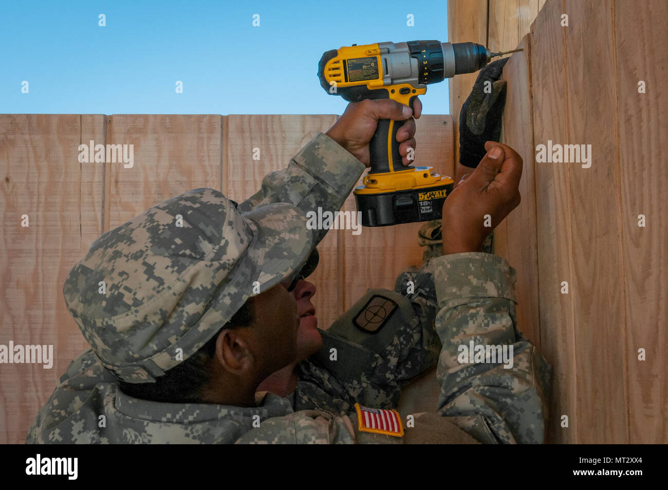 U.S. Army Reserve Spc. Michael Trice, a plumber, and Spc. Lance Coffman, in the rear, an interior electrician both of the 994th Engineer Company out of Denver, Colorado, install siding during the construction of a large storage shed at the YMCA of the Rockies-Snow Mountain Ranch, in Granby, Colorado, July 20, 2017. (U.S. Army Reserve photo by Spc. Miguel Alvarez, 354th Mobile Public Affairs Detachment) Stock Photo