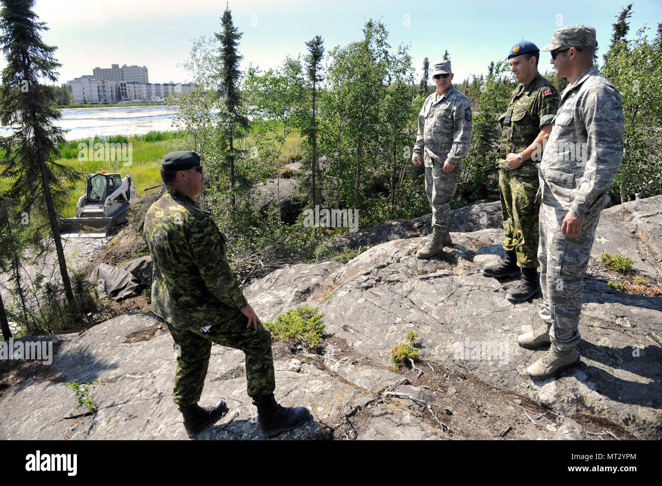 Oregon Air National Guard 142nd Civil Engineer Squadron (CES) and Canadian Armed Forces leaders discuss the Niven Lake trail extension, and other ongoing construction and repair projects that their members are working on around the City of Yellowknife, Northwest Territories, Canada, July 20, 2017.The CES members are spending two-weeks in Canada working on a variety of projects during their Deployment for Training (DFT). (U.S. Air National Guard photo/Master Sgt. John Hughel, 142nd Fighter Wing Public Affairs) Stock Photo
