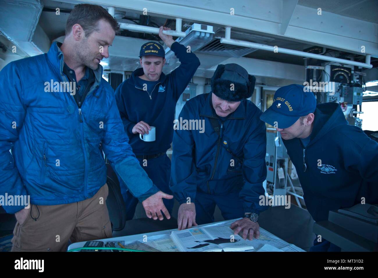 Scripps Institution of Oceanography scientist Joshua Jones (left) gives training on bowhead whales to watchstanders on the bridge aboard the Coast Guard Cutter Maple (WLB 207) underway in the Beaufort Sea, Alaska, on the cutter crew's historic voyage up through the Northwest Passage, July 22, 2017. The crew assisted Jones with zooplankton collection to analyze the abundance of the bowhead's food source. U.S. Coast Guard photo by Petty Officer 2nd Class Nathan Littlejohn. Stock Photo