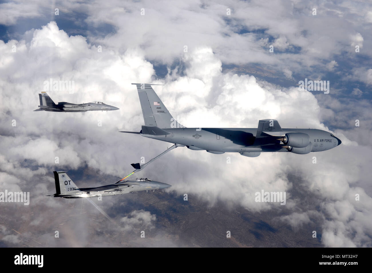 An F-15 fighter jet, assigned to the 433rd Weapons Squadron, at Nellis Air Force Base, Nevada, receives aerial refueling from a KC-135 Stratotanker cargo aircraft assigned to the 509th Weapons Squadron, at Fairchild Air Force Base, Washington, over the Nevada Test and Training Range July 10, 2017. The United States Air Force Weapons School teaches graduate-level instructor courses that provide the world's most advanced training in weapons and tactics employment to officers of the combat air forces and mobility air forces. (U.S. Air Force photo by Staff Sgt. Daryn Murphy/Released) Stock Photo