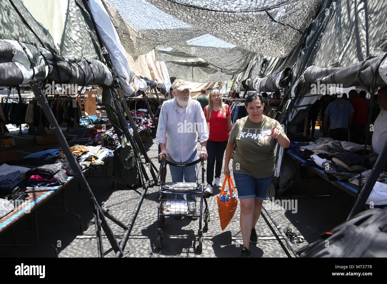 Two volunteers with the Veterans Village of San Diego help a veteran