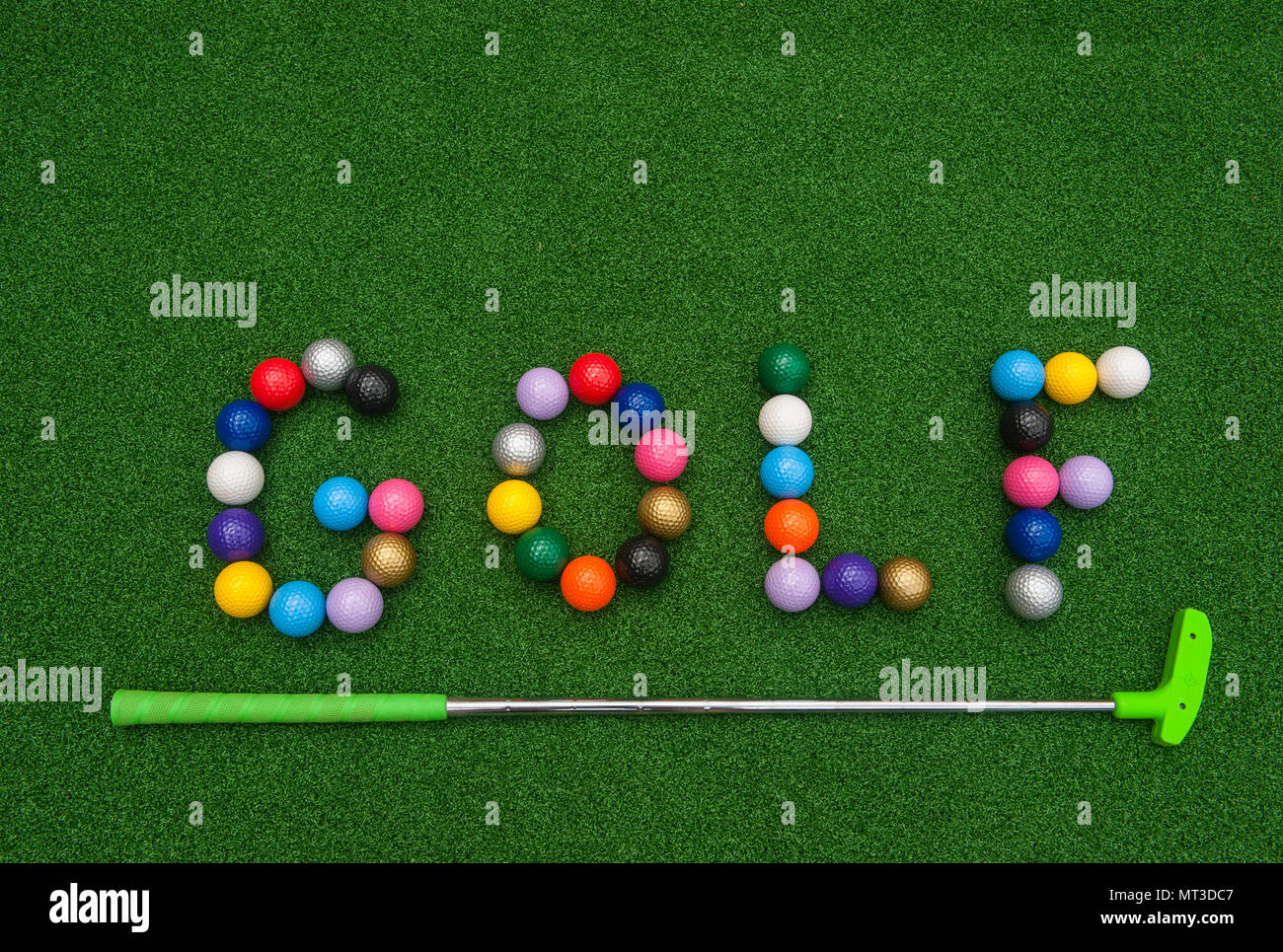 Colorful mini golf balls spelling Golf on artificial turf Stock Photo