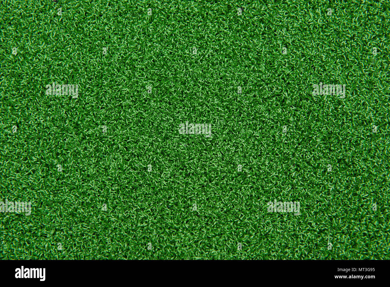 Background texture of synthetic grass or artificial turf used for mini golf and putt putt. Stock Photo