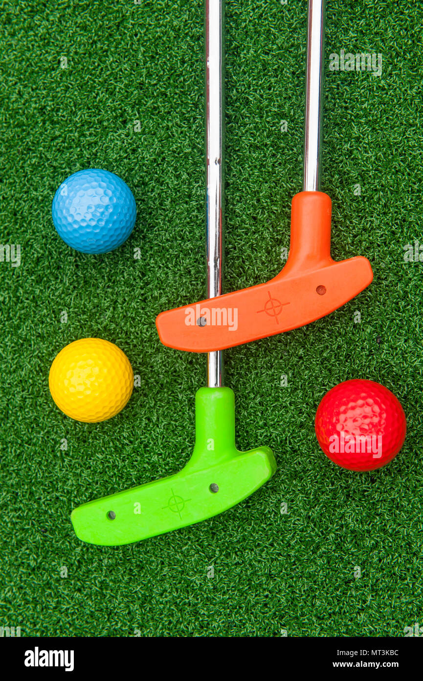 Colorful putt putt clubs and balls on artificial turf Stock Photo Alamy