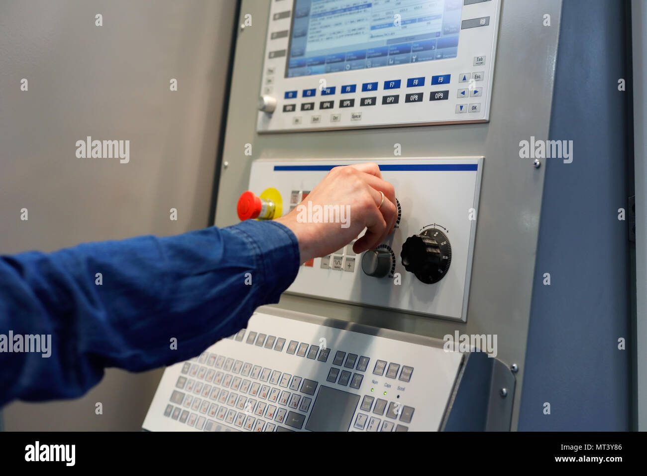 Adjustment of CNC machine operation parameters. Selective focus. Stock Photo