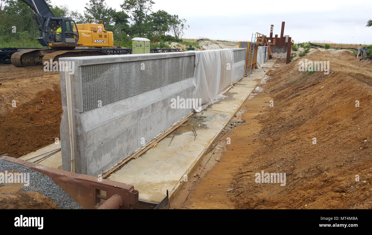 A concrete floodwall is being constructed to help reduce flooding as