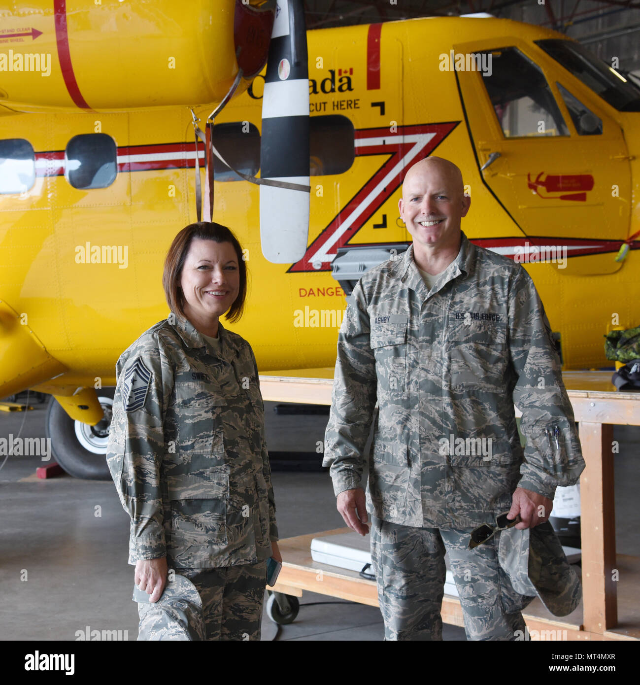 Oregon Air National Guard Chief Master Sgt. Nikese Swift, 142nd Fighter  Wing Command Chief Master Sgt. (left), pauses for a photograph with Senior  Master Sgt. Keith Ashby (right), assigned to the 142nd