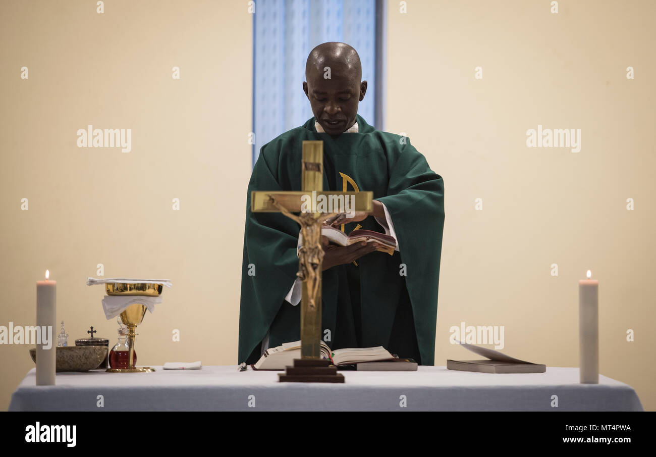Chaplain (Capt.) John Appiah, 455th Air Expeditionary Wing, recites a passage during a religious service at Hamid Karzai International Airport, Kabul, Afghanistan, July 23, 2017. Religious support teams from Bagram Airfield visit six different locations in Afghanistan where a chaplain is not deployed. (U.S. Air Force photo by Staff Sgt. Benjamin Gonsier) Stock Photo