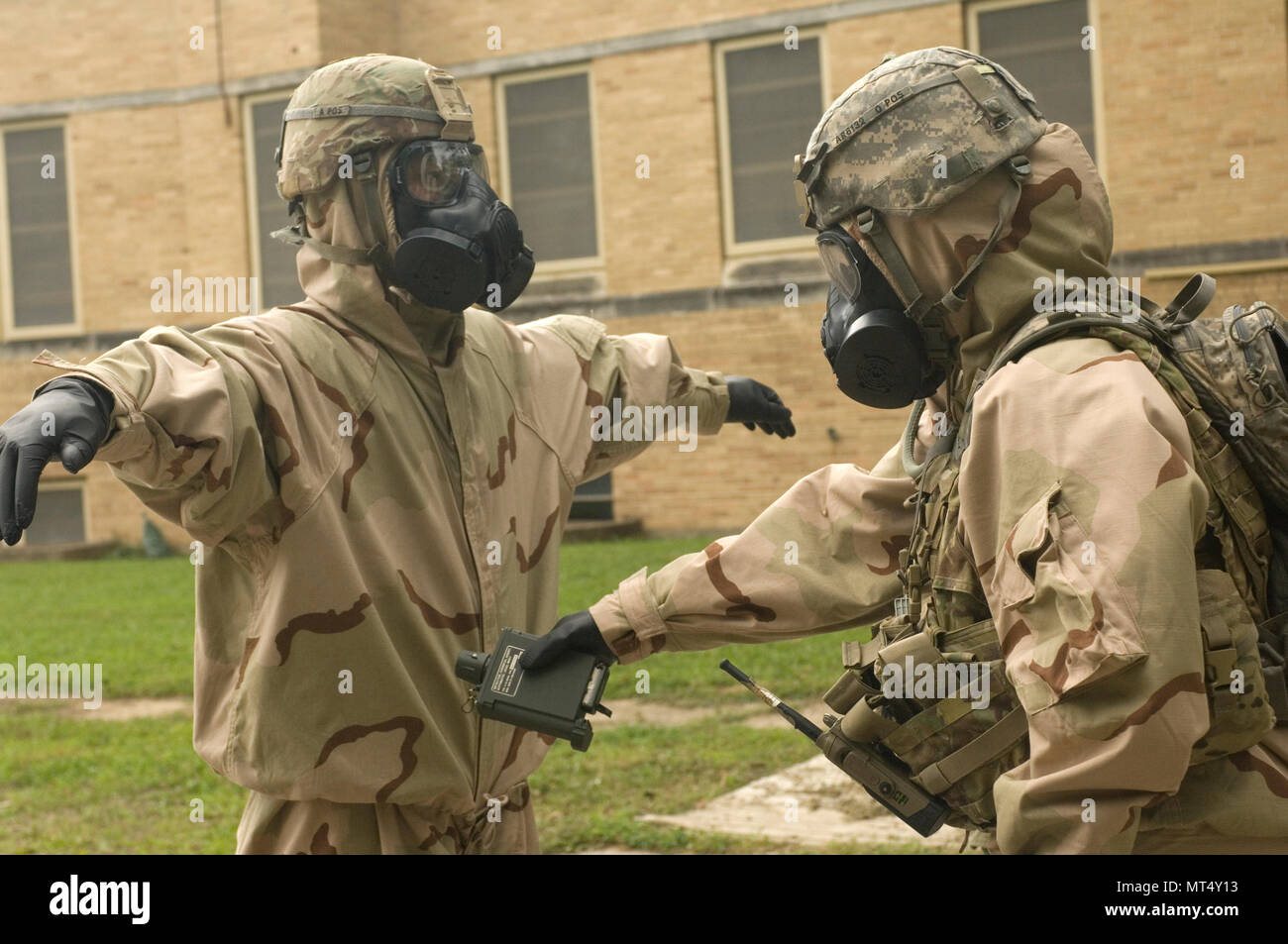 U.S. Army Soldiers assigned to the 65th Brigade Engineer Battalion (BEB), 2nd Brigade Combat Team, 25th Infantry Division simulate decontamination of the initial entry team returning from a site survey during a chemical, biological, radiological, nuclear (CBRN) exercise at Muscatatuck Urban Training Center, Ind., July 27, 2017. The 65th BEB, stationed at Schofield Barracks, Hawaii, is conducting urban training operations for two weeks in southern Indiana. (U.S. Army Reserve photo by Staff Sgt. Kenneth Burkhart) Stock Photo