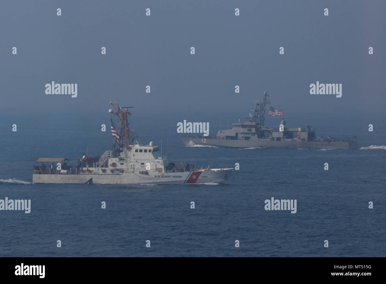 The USCGC “Maui” (WPB-1304), a U.S. Coast Guard Island-class Cutter, left, and the USS “Thunderbolt“ (PC-12), a U.S. Navy Cyclone-class patrol (coastal) ship, right, sail during a trilateral exercise in the Arabian Gulf, on July 25, 2017. The trilateral exercise, hosted by the U.S. Navy, incorporated the U.S. Army, Navy and Coast Guard, along with the Kuwaiti and Iraqi Navy and Coast Guard, in order to develop the skills and relations of the Coalition forces to work together in support of regional stability. (U.S. Army photo by Staff Sgt. Dalton T. Smith) Stock Photo