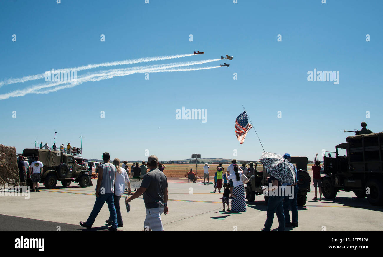 Service members and members of the local community watch as the Cascade Warbirds perform during the Skyfest 2017 Air Show and Open House at Fairhcild Air Force Base, Washington, July 29, 2017. SkyFest was an opportunity to give the local and regional community a chance to view Airmen and our resources. (U.S. Air Force photo/Senior Airman Janelle Patiño) Stock Photo
