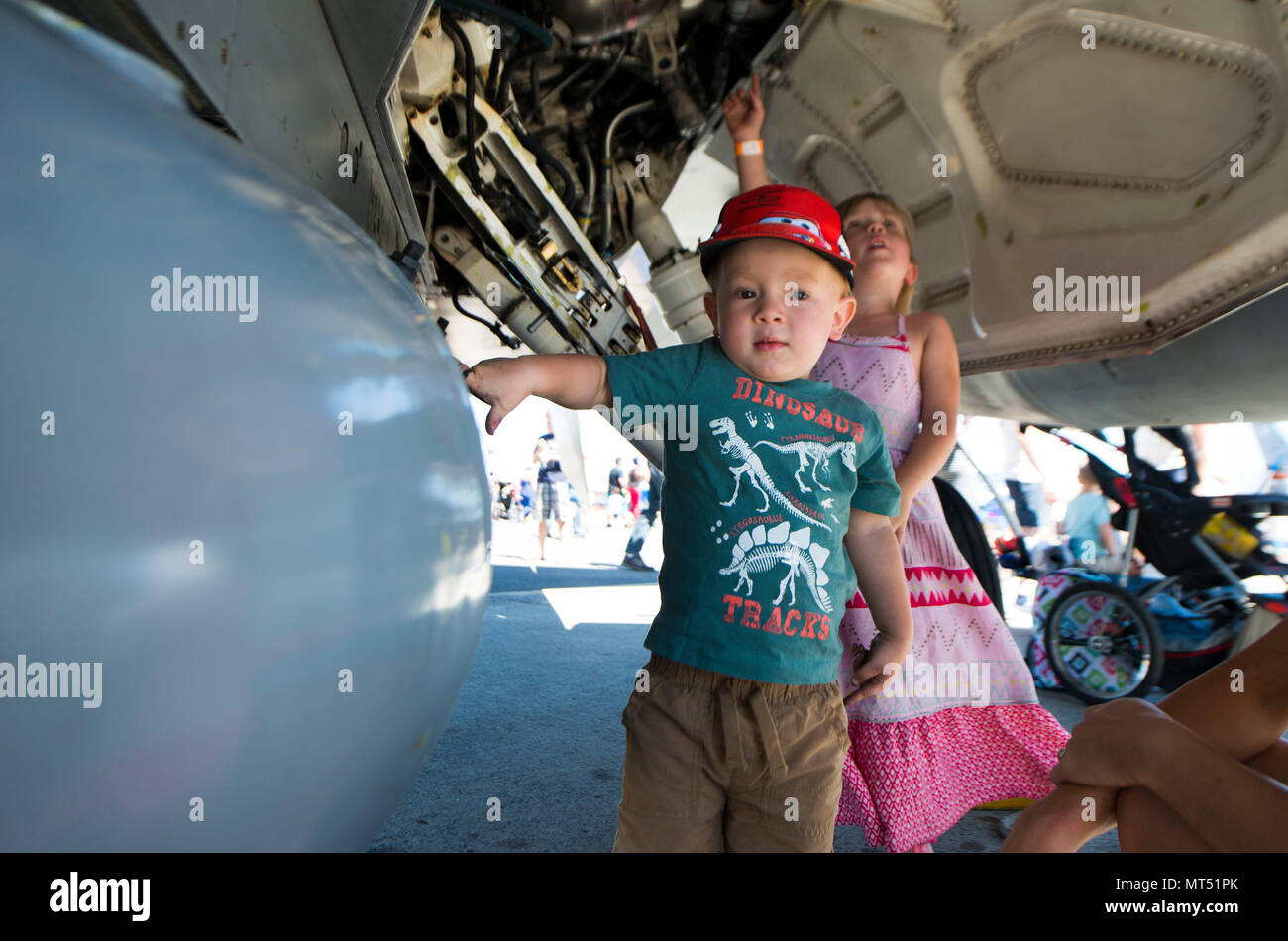 A child touches an aircraft during SkyFest 2017 Air Show and Open House at Fairchild Air Force Base, Washington, July 30, 2017. SkyFest was hosted  to thank the local and regional community for their support and give them the opportunity to meet Airmen and learn about the Air Force mission. (U.S. Air Force photo/Senior Airman Janelle Patiño) Stock Photo