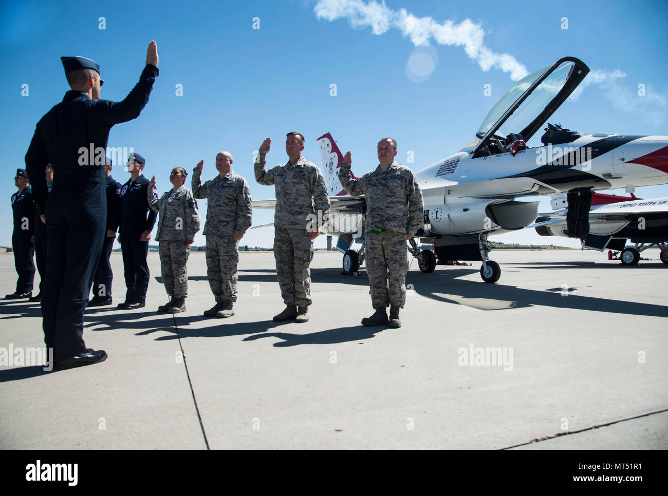 Lt. Col. Jason Heard, U.S. Air Force Aerial Demonstration Squadron “Thunderbirds” commander/leader, reenlists four members of Team Fairchild during SkyFest 2017 Air Show and Open House at Fairchild Air Force Base, Washington, July 28, 2017. SkyFest hosted more than 15 types of aircraft and static displays and more than 10 flying performers. (U.S. Air Force photo/Senior Airman Janelle Patiño) Stock Photo