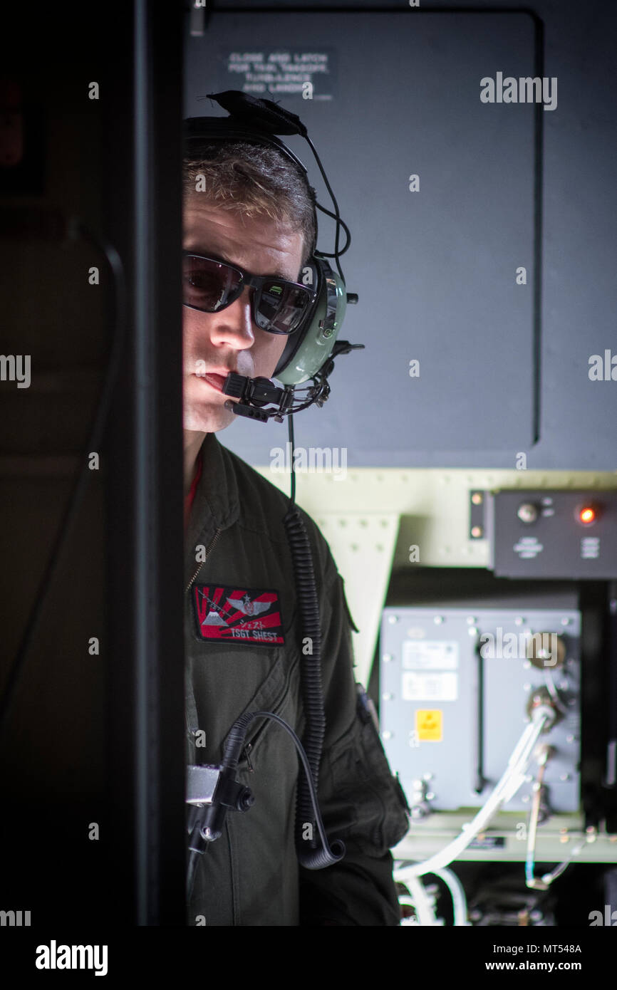Tech. Sgt. Benjamin Shest, 36th Airlift Squadron C-130J loadmaster, communicates with crew members at Yokota Air Base, Japan, July 28, 2017, during a training mission. This mission helped the loadmasters with the 36th AS maintain their airlift techniques to be ready to keep the mission going. (U.S. Air Force photo by Yasuo Osakabe) Stock Photo