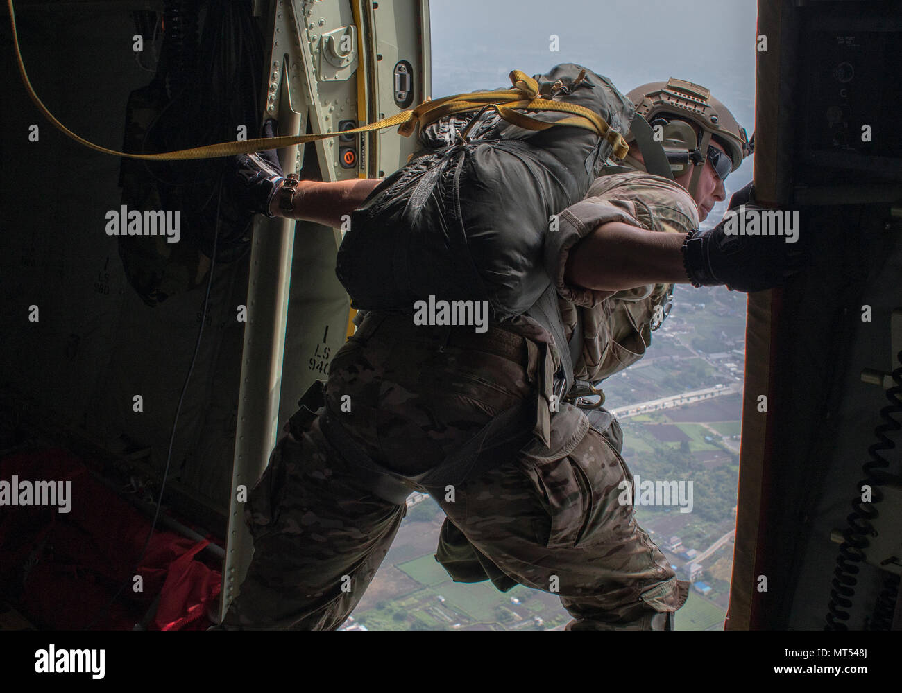 Staff Sgt. Justin Bender, 374th Operations Support Squadron survival, evasion, resistance and escape specialist, performs a visual confirmation over Yokota Air Base, Japan, July 28, 2017, during a static line jump training. Yokota SERE specialists conduct regular jump training to stay qualified and mission ready. (U.S. Air Force photo by Yasuo Osakabe) Stock Photo