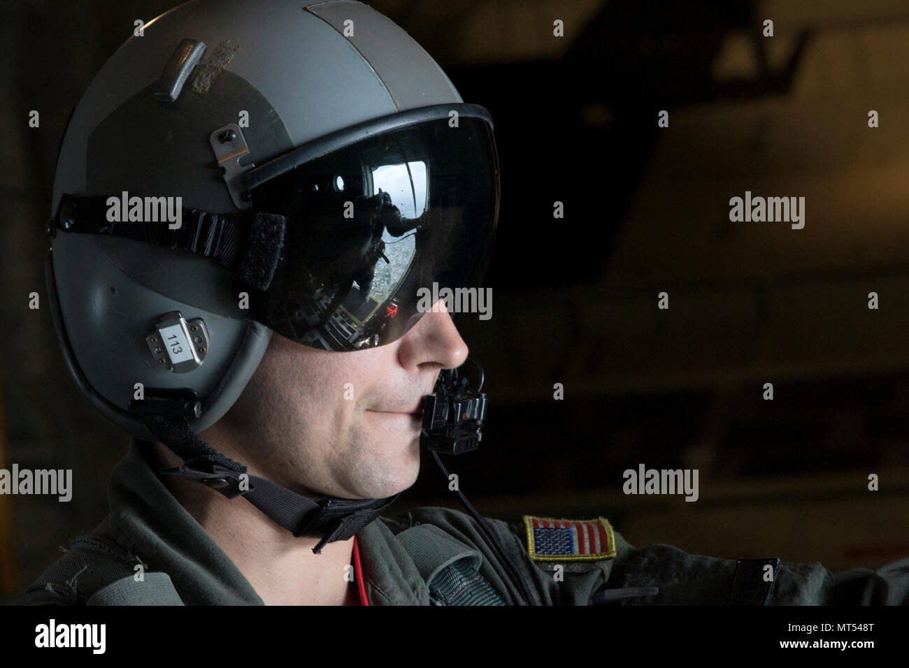 Tech. Sgt. Benjamin Shest, 36th Airlift Squadron C-130J loadmaster, observes a survival, evasion, resistance and escape specialist assigned to the 374th Operations Support Squadron perform his checks before executing a static line jump training over Yokota Air Base, Japan, July 28, 2017. This mission helped the loadmasters with the 36th AS maintain their airlift techniques to be ready to keep the mission going. (U.S. Air Force photo by Yasuo Osakabe) Stock Photo