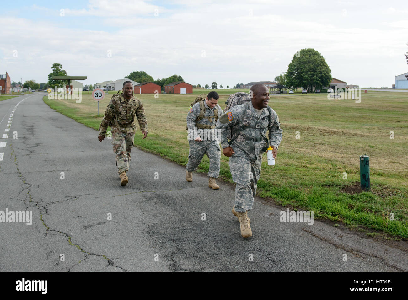 U.S. Army Lt. Col. Frank E. Jefferson Jr., left, Commander, Allied Forces North (AFNORTH) Battalion, walks with Sgt. Christian Sanchez and Staff Sgt. Alexander Ndifor, both assigned to Headquarters and Headquarters Company, AFNORTH Battalion as they take care of their physical condition by performing a 9-mile ruck march on Chièvres air Base, Belgium, July 20, 2017. (U.S. Army photo by Visual Information Specialist Pierre-Etienne Courtejoie) Stock Photo