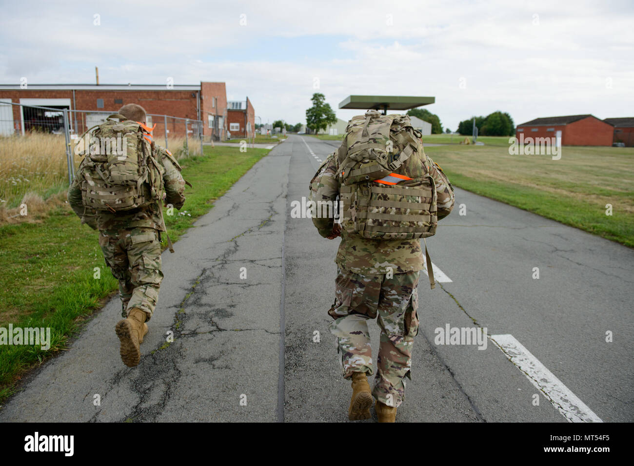 U.S. Soldiers assigned to Headquarters and Headquarters Company, Allied Forces North Battalion, take care of their physical condition by performing a 9-mile ruck march on Chièvres Air Base, Belgium, July 20, 2017. (U.S. Army photo by Visual Information Specialist Pierre-Etienne Courtejoie) Stock Photo