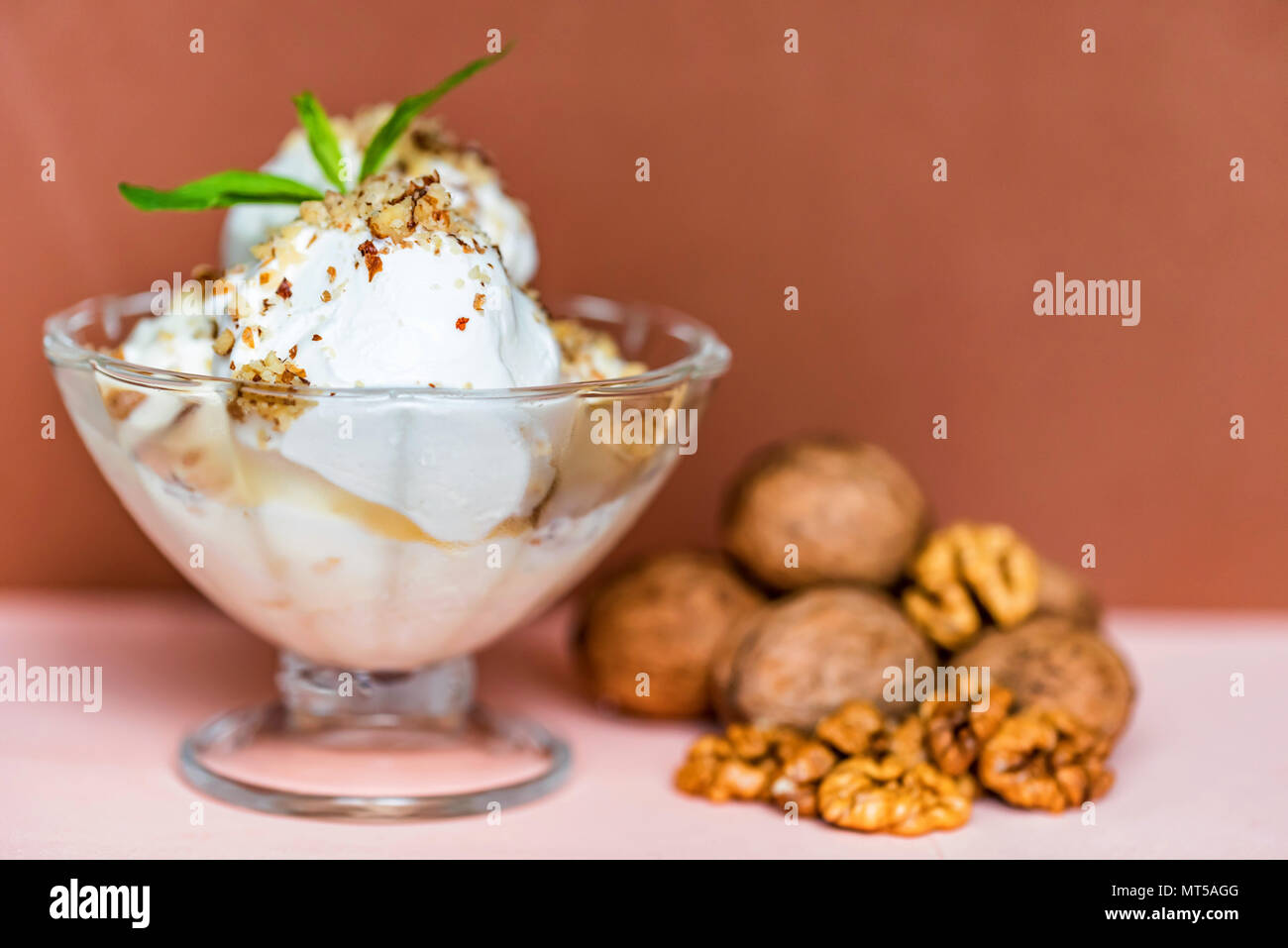 Vanilla ice cream in bowl and walnuts Stock Photo - Alamy