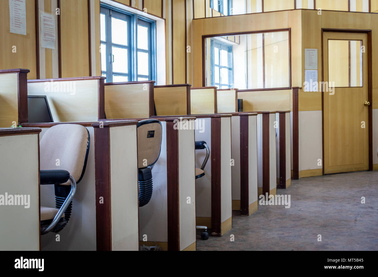 Small individual cabins with computers and chairs in an office Stock Photo