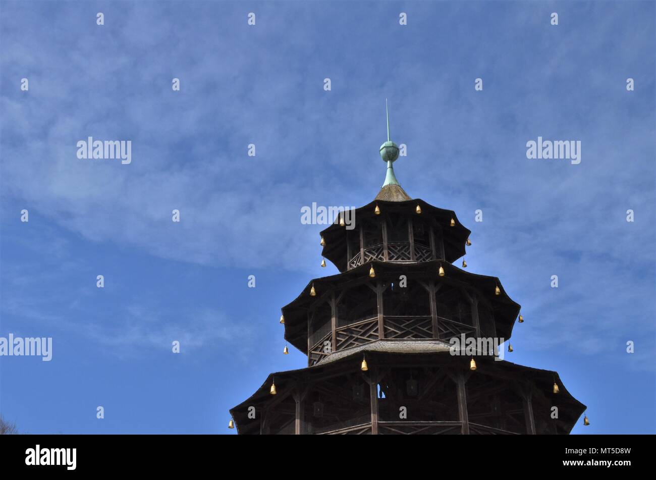 Chinese tower in English gardens in Munich in Bavaria in Germany with blue sky Stock Photo